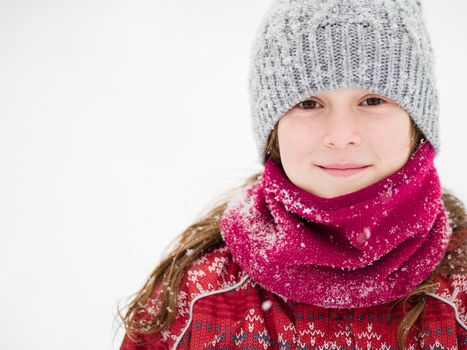 Cute young girl smiling in a snow storm