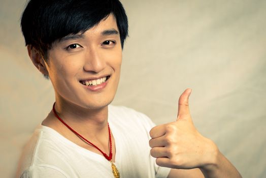 Young man gives thumbs up, with fashion tone and background