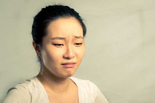 Portrait of young woman crying desperately, with fashion tone and background