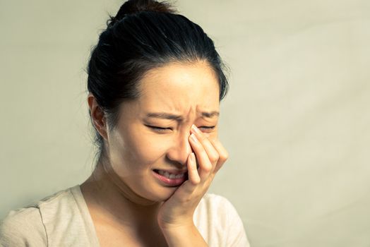 Portrait of young woman crying desperately, with fashion tone and background