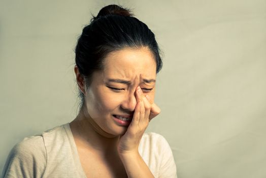 Portrait of young woman crying desperately, with fashion tone and background