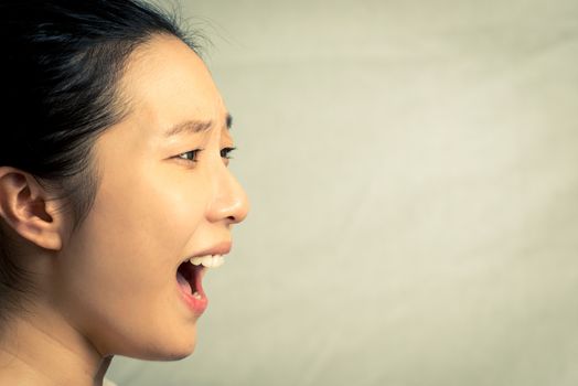 Young woman shouting, with fashion tone and background