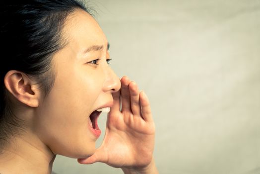 Young woman shouting, with fashion tone and background