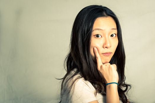 Young woman with a cute pose and rolling eyes, with fashion tone and background