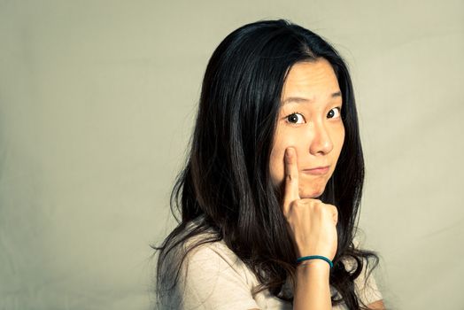 Young woman with a cute pose and rolling eyes, with fashion tone and background