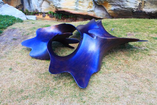 Bondi  Australia - November 3,  2013: Sculpture By The Sea, Bondi 2013.   Sculpture titled 'Organism 2013 #1' by Seung-Hwan Kim (South Koria).  Medium - bronze  $55000  It is reflecting the sky and water.