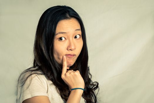 Young woman with a cute pose and rolling eyes, with fashion tone and background