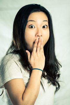 Young woman looking surprised, with fashion tone and background