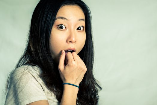 Young woman looking surprised, with fashion tone and background