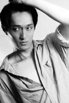 Fashion pose by a young male model, with black and white color and background