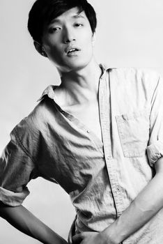 Fashion pose by a young male model, with black and white color and background