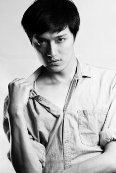 Fashion pose by a young male model, with black and white color and background