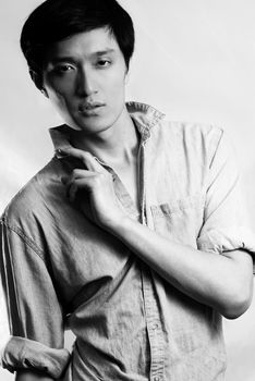 Fashion pose by a young male model, with black and white color and background