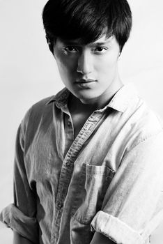 Fashion pose by a young male model, with black and white color and background