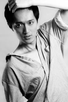 Fashion pose by a young male model, with black and white color and background