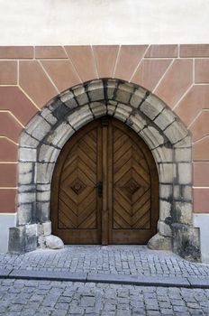 Gothic style, wooden door in european medieval town.