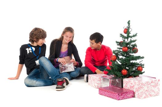 Two boys and a girl, celebrating Christmas on a white background