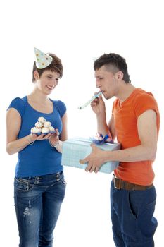 a happy boy is having a present for his birthday girl on a white background