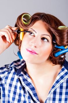 portrait of attractive woman applying eyeliner