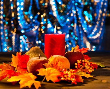 Candles in nice and beautiful colorful autumn leaves