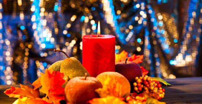 Candles in nice and beautiful colorful autumn leaves