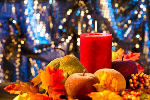 Candles in nice and beautiful colorful autumn leaves