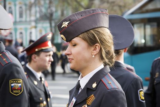  St. Petersburg, Russia -  May 9: The girl police officer costs  in a cordon on Palace Square during parade   in the city St. Petersburg, Russia May 9, 2013. In the city of St. Petersburg annually on May 9 passes parade with participation of military equipment, the USSR devoted to a victory in the Great Patriotic War.  