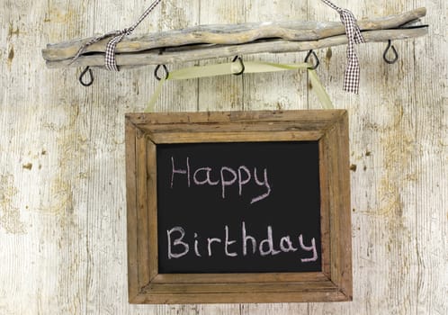 happy birthday board on wooden background