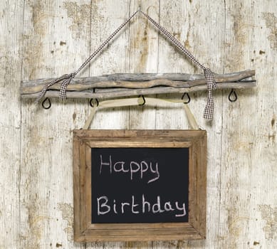 happy birthday board on wooden background