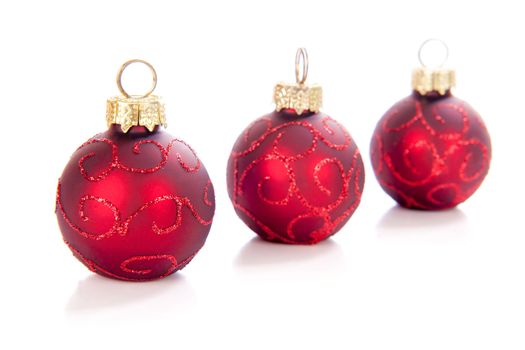 Three christmasball in a row on a white background