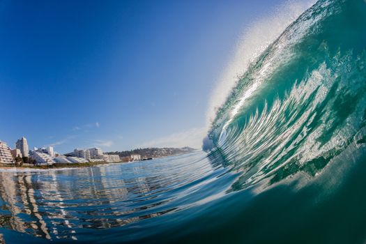 Water photo perspective of smooth glassy ocean wave vertical hollow and crashing towards shoreline at holiday resort town of Balito Bay South-Africa