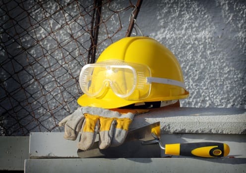 Bricks, trowel and helmet on work place 