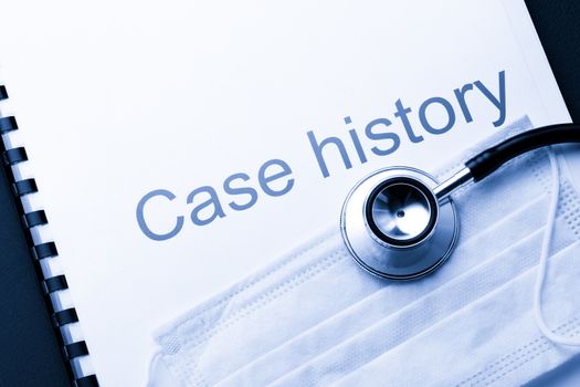Case history, stethoscope and mask on black