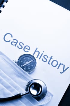 Case history, stethoscope, compass and mask