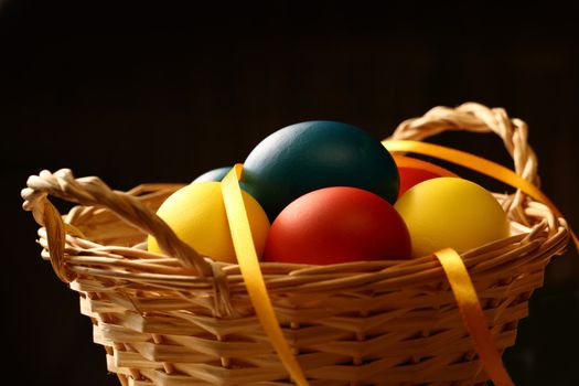 Easter eggs with yellow ribbon in basket