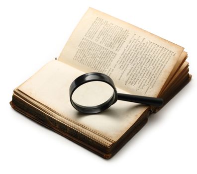 Magnifying glass and old book on the white background