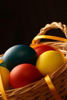 Easter eggs with yellow ribbon in basket