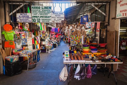Asian shops though narrow walking arcade selling their goods and products to passing public in Durban South-Africa