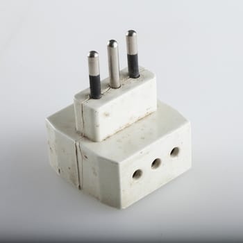 Three way electric adapter over white background