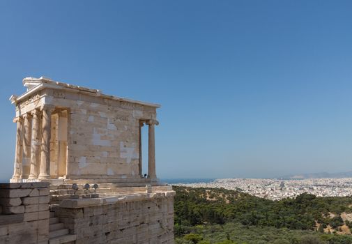 The Temple of Athena Nike is a temple on the Acropolis of Athens. Built between 427 and 424 BC, the temple is the earliest fully Ionic temple with a prominent position on a steep bastion to the right of the entrance, the Propylaea