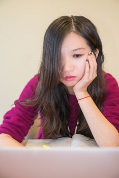 Young woman working and studying on a laptop