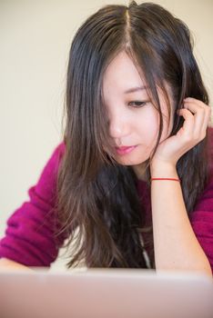 Young woman working and studying on a laptop