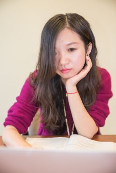 Young woman working and studying on a laptop