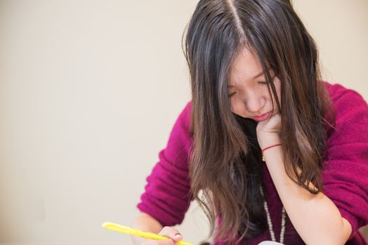 Woman studying with pen in hand