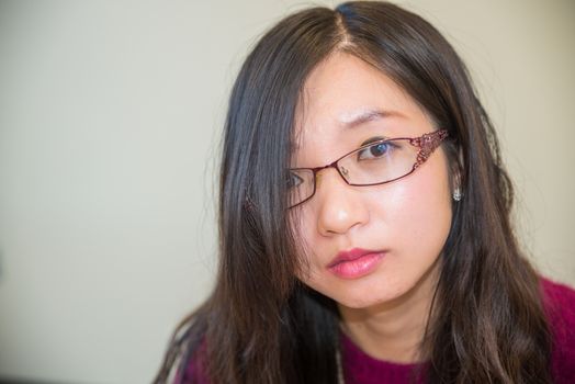 Close portrait of young woman with glasses