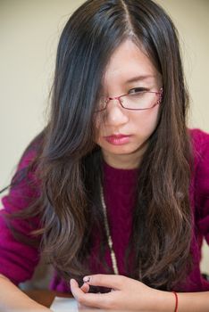 Portrait of young woman with glasses and book