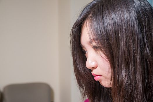 Close portrait of young woman looking depressed