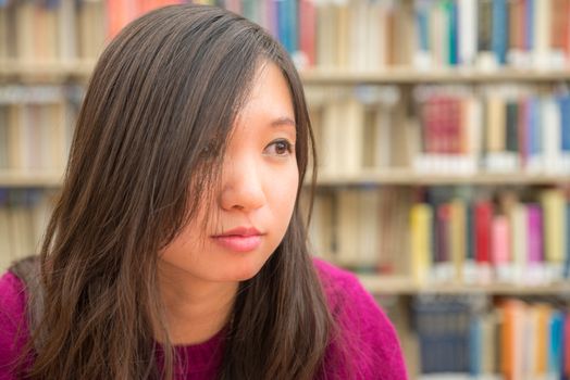 Close portrait of young woman in library