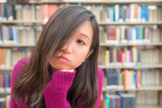 Close portrait of young woman in library