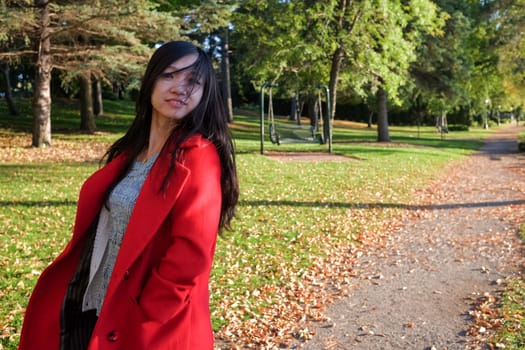 Woman at the end of a road swinging her hair